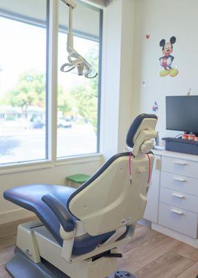 Private treatment room with overhead TV for patients to enjoy