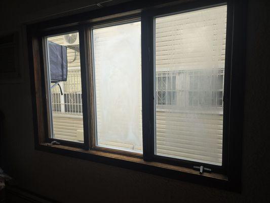 Before picture. 2 window panes with major condensation issues. One window rolls out and the other doesn't open