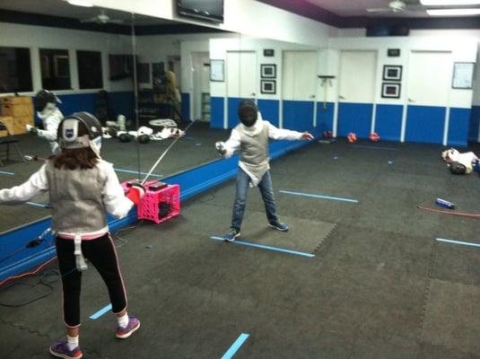 Two students practice foil fencing during a week long TMCC/Washoe County School District fencing camp!