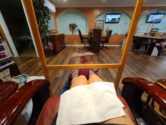 In my pedicure station, sink to wash hands is in front of me. Massage room to the left (in the open door).