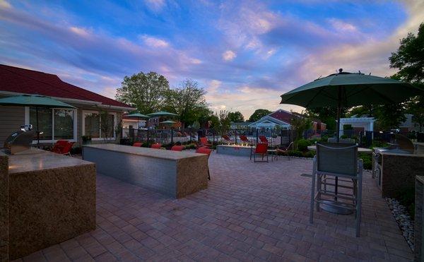 Grilling stations and fire pit with lounge seating at Haven