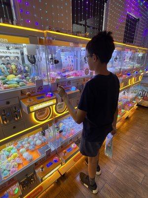 My son loving the fun claw machine where you can win cool prizes!!  Genius idea for the kids!