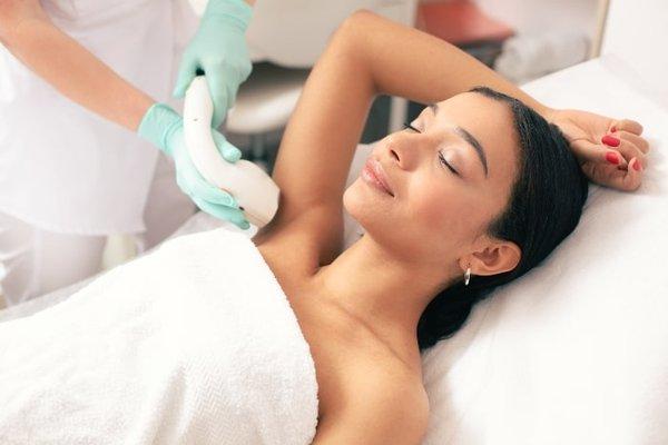 A woman at Georgetown Rejuvenation receiving laser hair removal, opting for a lasting solution after struggling with the hassle of shaving