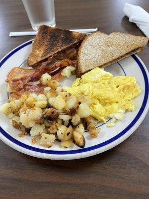 Bacon and Egg breakfast with home fries and wheat toast.