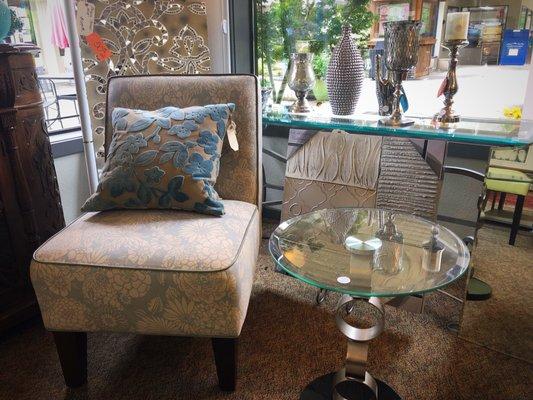 Decorative pillows, glass artwork, slipper chair, and glass table!