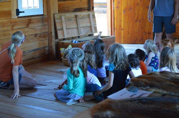 Learning about all the pelts from a young worker at the fort