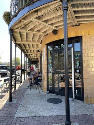 Entrance with some shady outdoor seating on a nice day