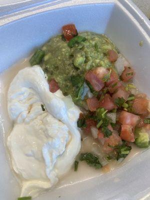 Sour cream, guacamole and pico that comes with the enchilada