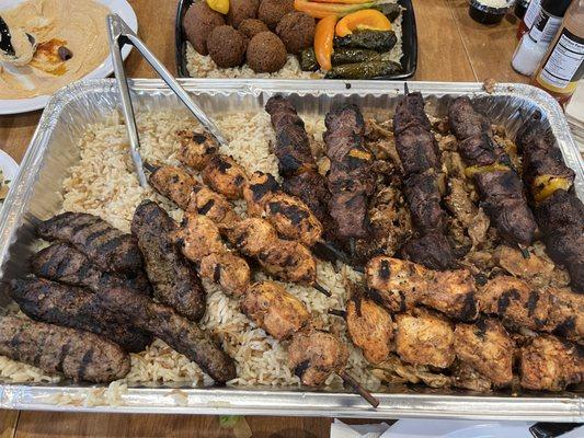 bed of rice under chicken shawarma, chicken kabob, beef kabob, shish kafta