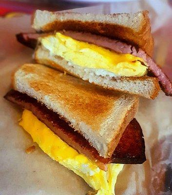 Thick sliced bologna, egg, and cheese breakfast sandwich on toast.  Old school sammie.