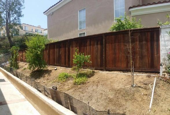 Installed new wood fence and applied wood preservative to extend the service life of wood fence.