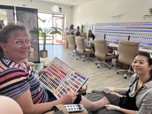 Mother getting a pedicure and choosing a color :)