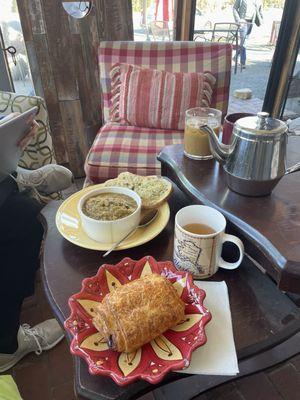 Chocolate croissant, tea pot, cup of soup, latte