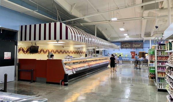 Butcher, meat and seafood counter towards the rear