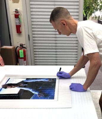 World renowned fashion photographer Markus Klinko signing a print of David Bowie we produced for him.