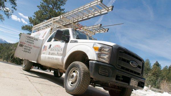 The Mountain Hearth & Patio installation truck sits on the driveway outside a Conifer, CO home.