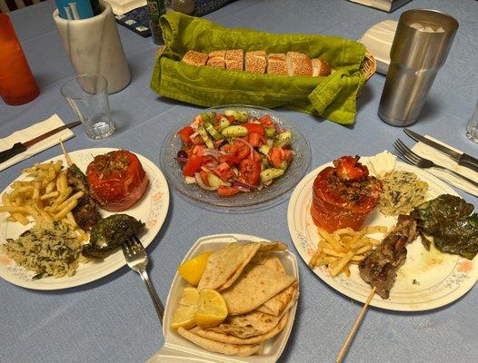 Stuffed peppers, pork souvlaki with fries and rice, and dolmades.