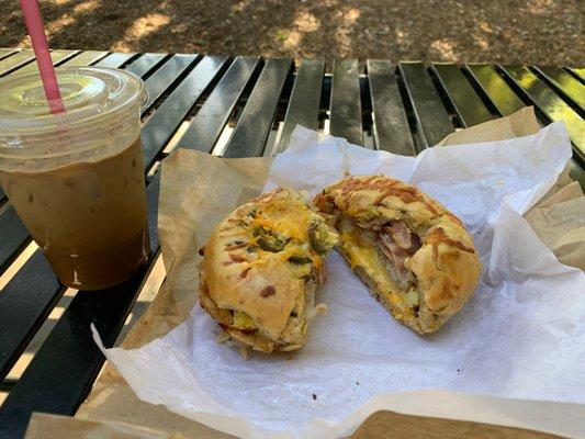 Bacon, hash brown, egg and cheese on a jalapeno bagel with a vietnamese coffee