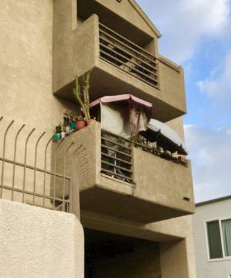 Homeless encampment on balcony.