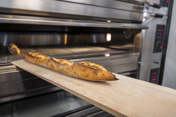 Stevedore Baking Bread Out Of Oven