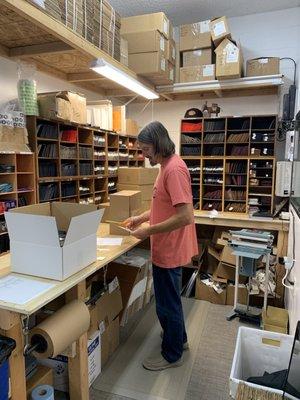 Tim packing up orders!