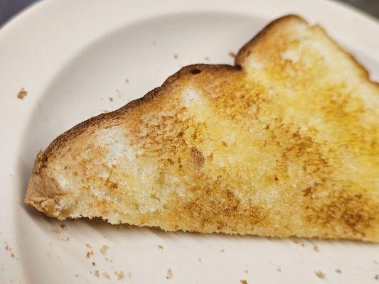 Close-up of a slice of buttered white toast from the Texas Tavern.