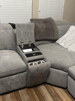 Cup holder and remote holders. Has usb chargers inside and on the sides of the couch where you can recline.