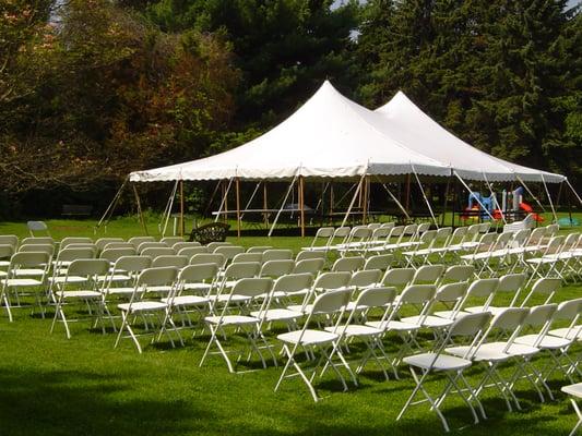 30' x 45' Century Mate Pole Tent with wedding ceremony chairs in foreground.