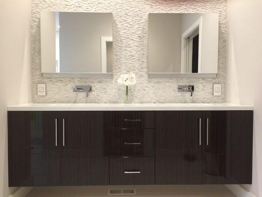 Floating vanity with Robern mirrors sunken into a walk of stack stone.