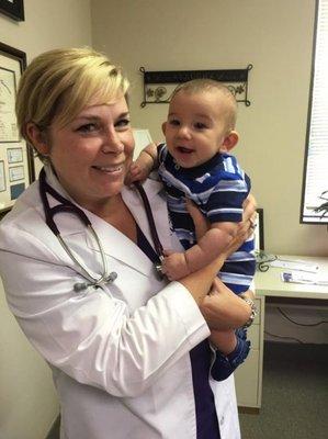 Dr. Betsy McCormick holding a baby