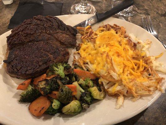 Ribeye, lyonnaise potatoes with cheese, roasted vegetables