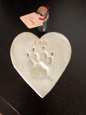 Sam's paw print and the glass holder with fur cuttings.