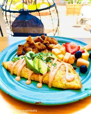 Vegan Just Omelet: Just Egg, Mushroom, Onion, Corn, Poblano, Cheddar, Chili Mayo, Avocado, Fruit, Breakfast Potatoes