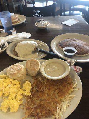 Country fried steak with eggs and one pancake