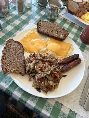 Eggs, brown bread, bangers and corned beef.