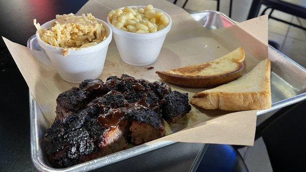 Burnt ends entree with loaded potatoes and mac n cheese served with Texas toast.