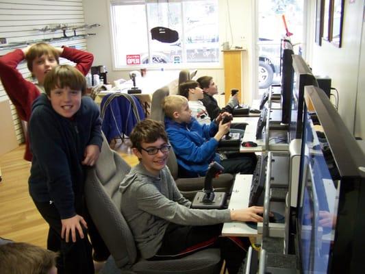 Happy kids having a dogfight against one another on our networked flight stations. His first birthday party! They came back again this year!