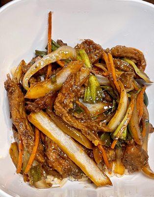 Mongolian beef- tender beef strips, julienne carrots, onion slices & green onion in a sweet and savory soy sauce over brown rice