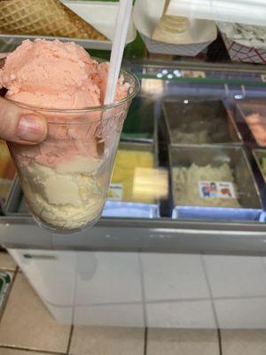 Double scoop in a cup. Half guava and coconut ice cream