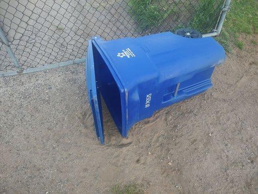 Illegally dumped recycling container over my fence in my driveway