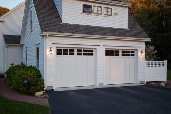 Haas steel carriage house garage doors with composite overlays and 6 pane square windows