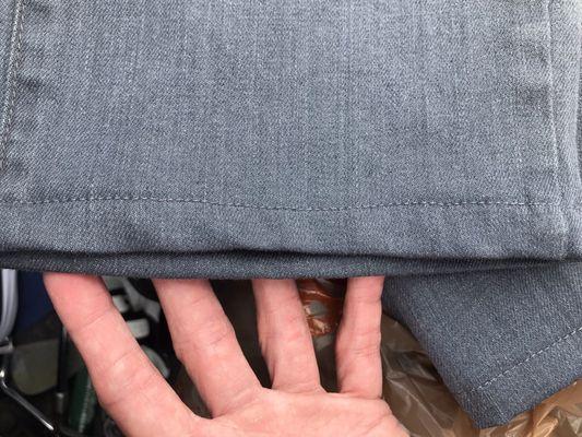 Uneven edge on hemmed jeans.