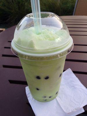 Honeydew slush with boba drink.