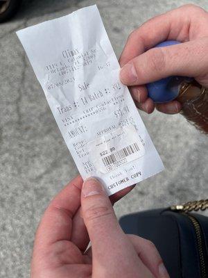 Receipt and sticker with price discrepancy.