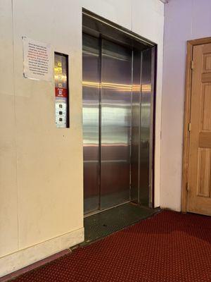 Zoom into the sign posted next to the only working elevator