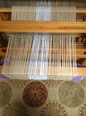 Warping up the loom.