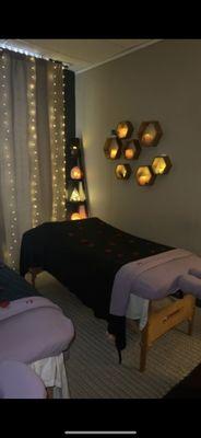 Rose petal covered massaging bed, Himalayan crystals, LED curtain lights.