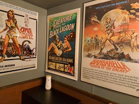 Inside the restroom, which has retro movie posters