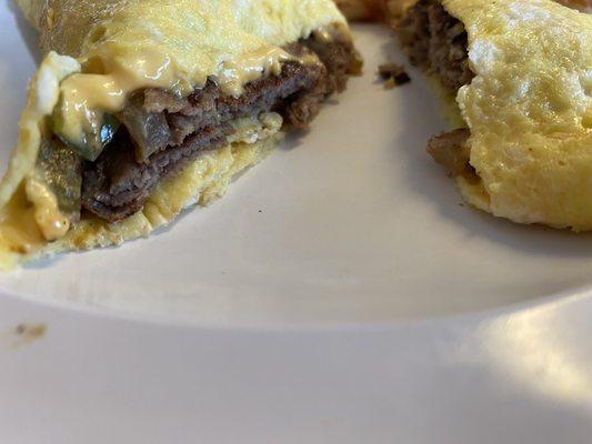 Inside of the omelette. Decent (not fatty) steak, green peppers, cheese.