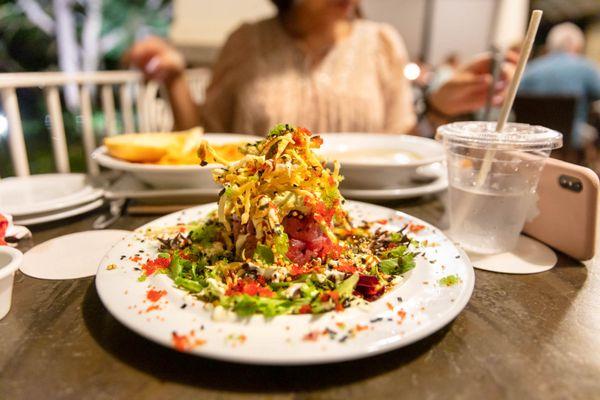 Ahi Poke Stack $18 "ahi poke, kiawe smoked sea salt, won ton chips, mesclum greens, avocado mousse, pickled ginger juice, tobiko caviar"